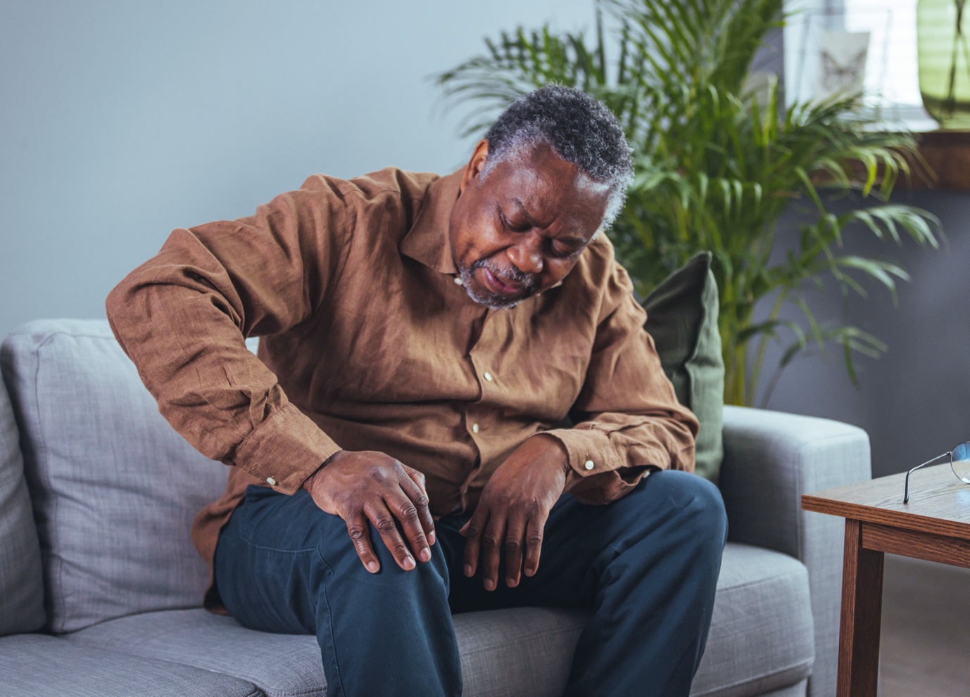 man sitting on sofa