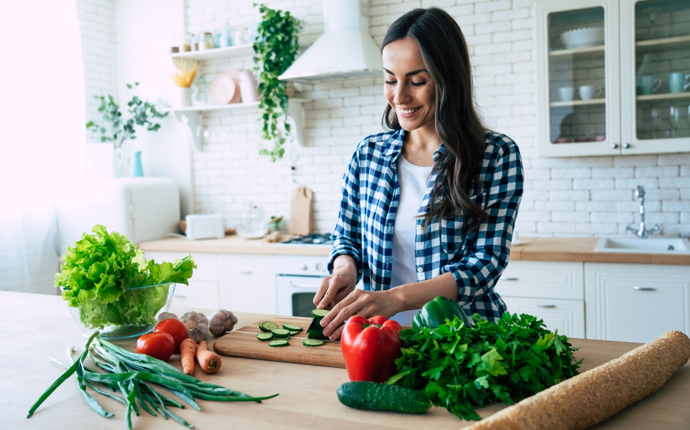 woman preparing fresh vegetables in kitchen