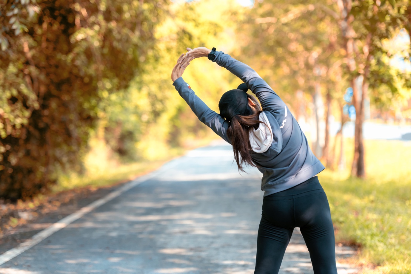 woman stretching at park