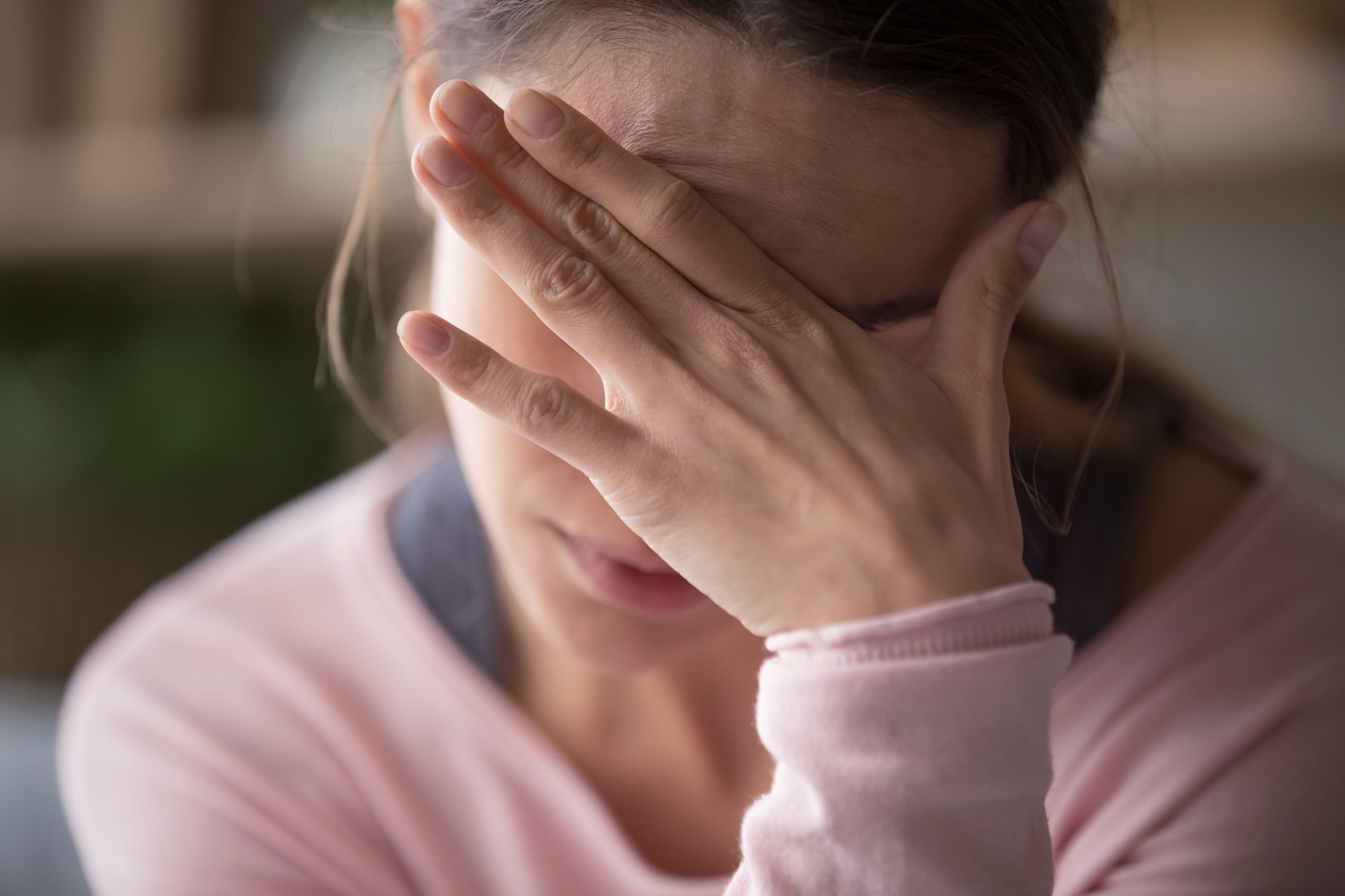 woman rubbing brow