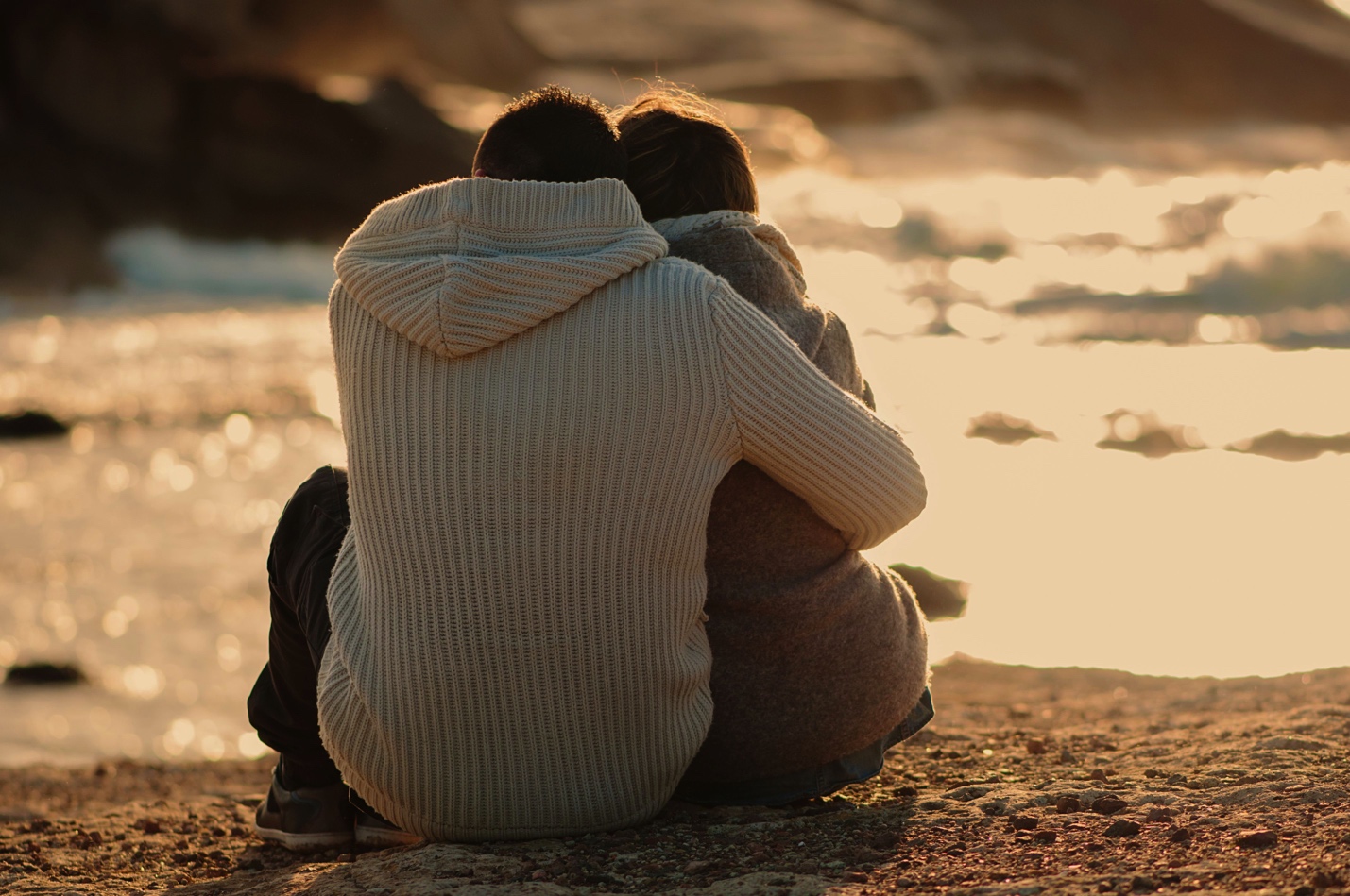 couple embracing near river