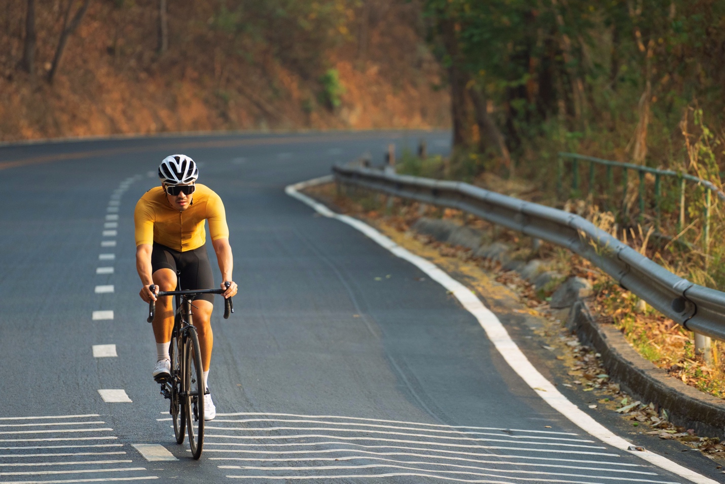 man riding road bike