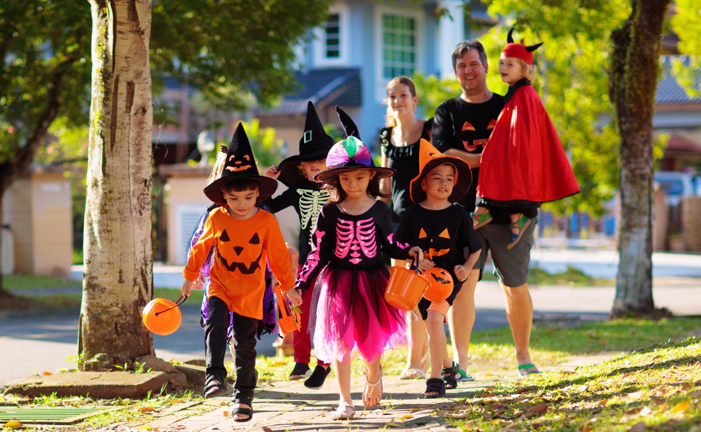 Kids trick-or-treating with adults