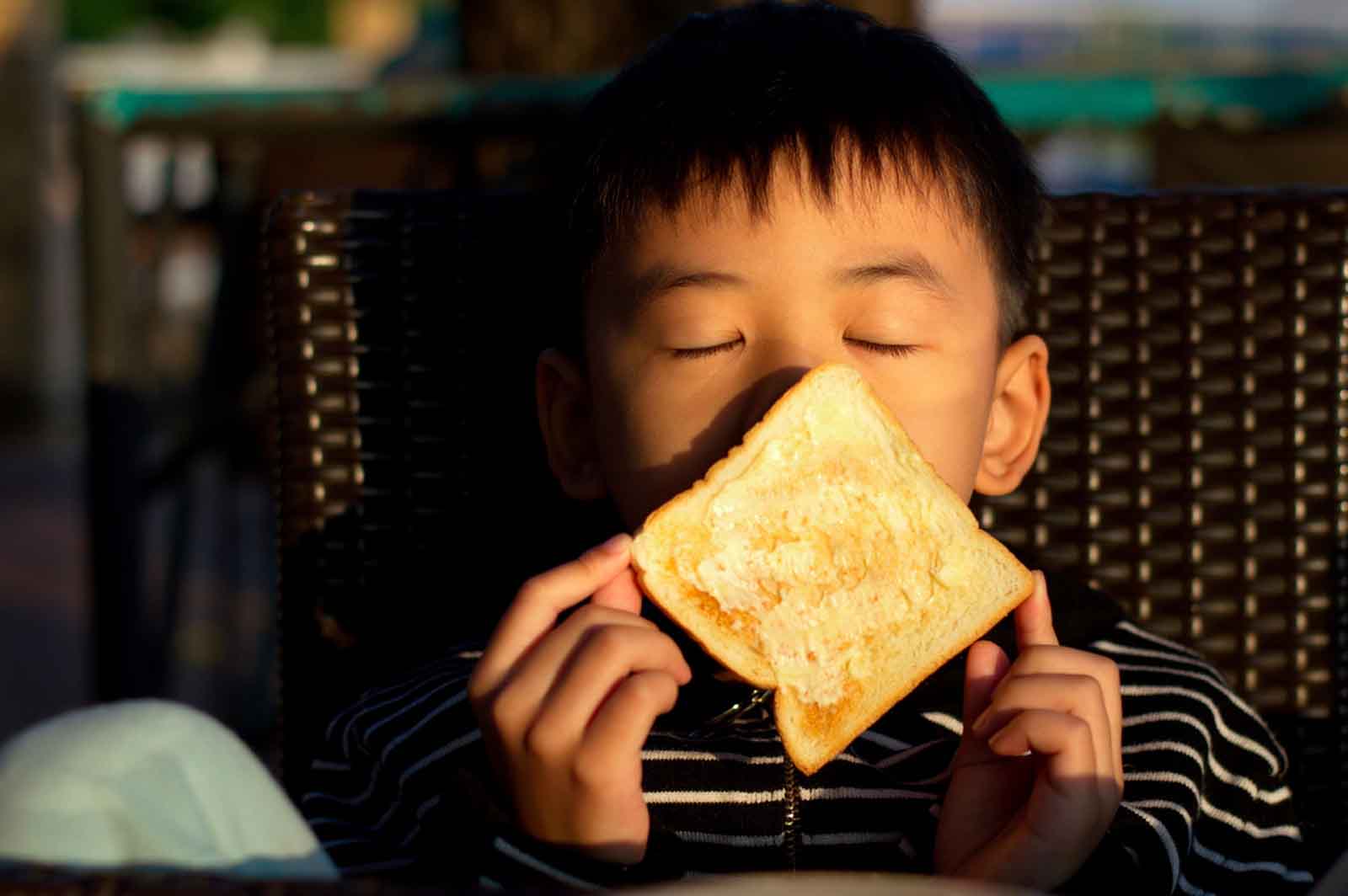 boy smelling toast